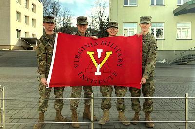 Four cadets hold up a ֻ̳flag in Lithuania